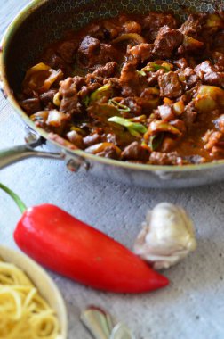 delicious pasta with tomato sauce, beef prklt with sour peppers and mushrooms, top view clipart