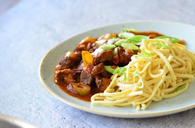 delicious pasta with tomato sauce, beef prklt with sour peppers and mushrooms, top view clipart