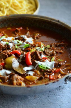 close up view of traditional Hungarian dish beef perkelt, served on a plate with spaetzle clipart