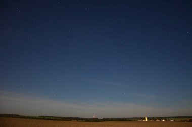 Ufkun üzerinde C / 2023 A3 kuyruklu yıldızının (Tsuchinshan-ATLAS) fotoğrafı, arka planda yıldızlı gece gökyüzü, panorama manzarası, Silesia, Hnevosice, Çek Cumhuriyeti 15 Ekim 2024