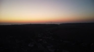 Dağlarda bir köyün üzerinde gün batımı, köyde bir tepenin üzerinde bir köy..