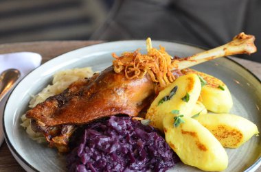 roasted goose leg with red cabbage and dumplings clipart