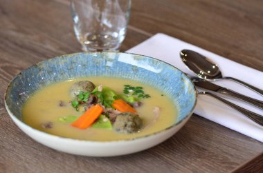 close view of traditional Czech food, Kaldoun goose soup, served food on a plate in a restaurant, wooden table, Saint Martin's goose, traditional Czech holiday food clipart