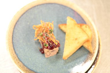 A traditional Czech dish featuring creamy pork pt, served with tangy cranberries, crispy fried onions, and slices of toasted homemade bread. clipart