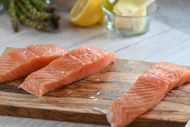 Yüksek kaliteli çiğ somon filetosu. Canlı turuncu bir tonu var. Açık arkaplanda güzelce yerleştirilmiş.