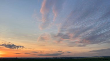 Gökyüzünde birkaç bulut olan bir gün batımı