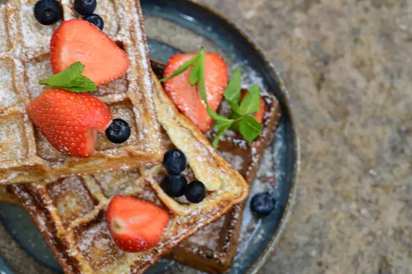 Taze çilekli waffle, çikolata ve yabanmersini..