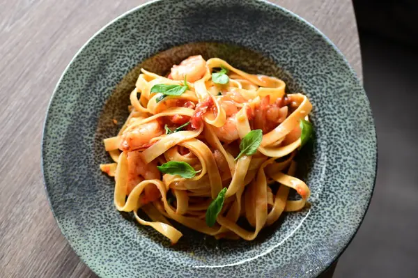 Siyah tabakta karidesli makarna.