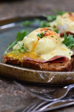 Jambonlu haşlanmış yumurta ve siyah tabakta tost.