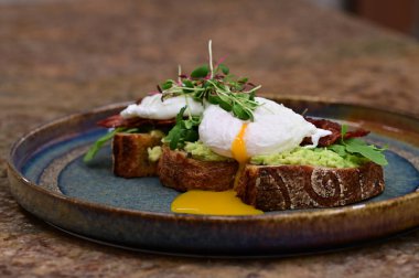 Kavrulmuş yumurta ve avokado ile tost.
