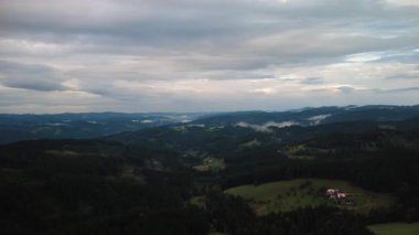 aerial drone view of mountains with clouds and fog