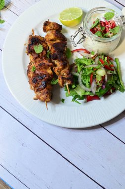 chicken chicken wings with salad on wooden table
