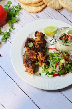 kebab with pita bread and fresh salad on the table