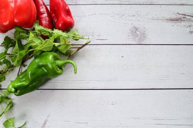 fresh red bell peppers, garlic on a wooden background