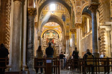 Kilisedeki ayinlere Bizans freskleri ve altın mozaiklerle katılan insanlar pencereden içeri güneş ışığı giriyor. Amiral St. Mary Katedrali, Martorana Kilisesi. Sicilya, Palermo, İtalya. Kilisede gün ışığı