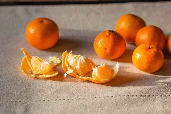 stock image Pile of ripe orange tangerine fruits isolated on a linen tablecloth. Healthy eating and diet with fruits concept. Traditional sweet food for winter holidays. Preparation to New Year or Christmas eve.