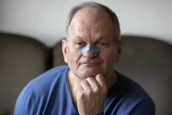 Smiling Senior Man Applying Black Nose Patch Clean Pore Skin — Fotografia de Stock