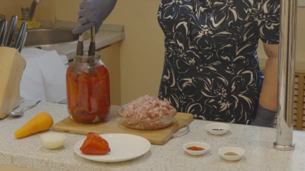 Woman Takes Fermented Peppers Out Glass Jar Places Them Plates — Stock Video