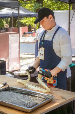 Almaty, Kazakistan - 5 Ağustos 2023. Elleri hamurdan yapılmış yemek sokak kafesinde Asya yemekleri için erişte yapar.