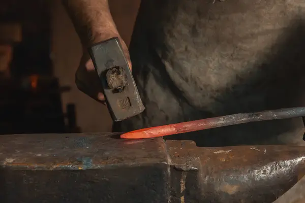 stock image Red-hot metal part on an anvil under a blacksmith's hammer. Close-up