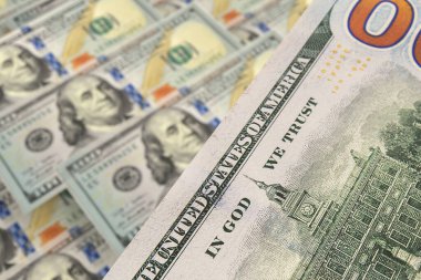 Arka planda dolar banknotları olan 100 dolarlık banknotun arkası. Döviz piyasası. Finans kavramı