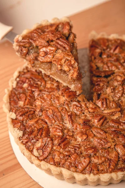 Stock image delicious homemade pecan pie with caramel and nuts.