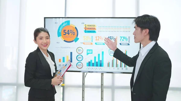 两名专业亚洲商人在电视上介绍公司成长数据策略 供办公室工作坊上解释 — 图库照片
