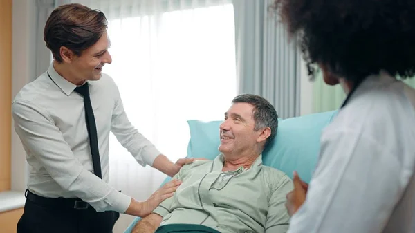 Happy Son Visits Recovering Old Father Lying Bed Hospital Talked — Stock Photo, Image