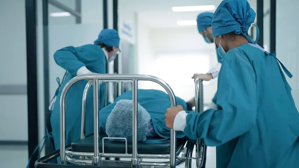 Egyenruhás Orvosi Csapat Segít Tolni Beteg Ágyát Kórházi Sürgősségi Osztályon — Stock Fotó
