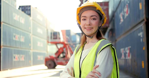 Professional woman engineer worker wearing hard hat standing and cross arms looking at camera