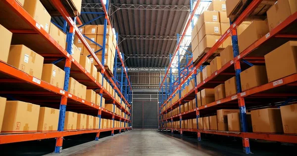 Rows of shelves with goods boxes in industry warehouse store at the factory warehouse storage