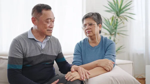 Asian elderly old couple comforting and express empathy. Elderly man caring wife holding hands supporting giving sympathy loving. Couple retirement lifestyle