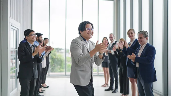 Business success concept. Happy business people clapping hands for congratulating success business. Diverse employees clapping hands congratulating to man colleagues