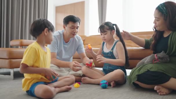 아시아 가족들은 휴일에 거실에서 시간을 보낸다 자녀와 그리고 색깔의 장난감을 — 비디오