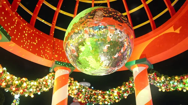 Disco ball glow decorated for Christmas festive and celebration. Neon Disco ball flickering light bulbs garlands winter holiday. Happy New Year. Festival mood