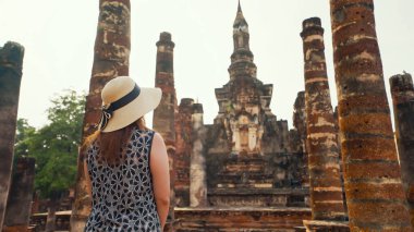 Eski yerler, Sukhothai, Tayland 'da turistik yerler. Turist kadının Wat Mahatat Tapınağı, Sukhothai tarihi parkı, Sukhothai, Tayland 'a gelişi. UNESCO Dünya Mirası