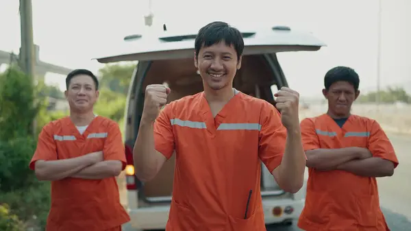 Excited Three Asian Man Rescue Team Uniform Making Winning Pose Stock Picture