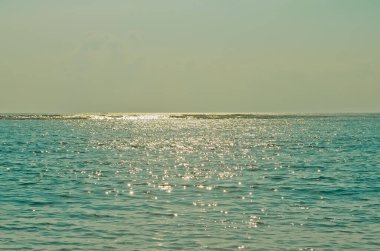 Kayalıkların, denizin, dalgaların ve ufukların ardında açık bir gökyüzü, Uluwatu Bali