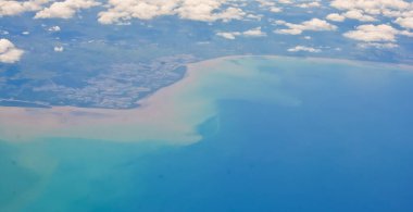 View from space of island landscape with sedimentation in the sea, Indonesia