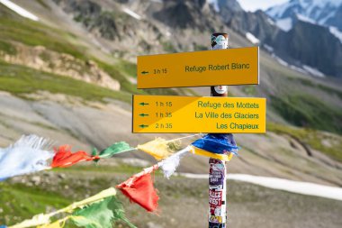 The signpost on the Col de la Seigne mount with hiking directions and timing.  clipart