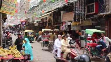 Stock video of people walking in hustle bustle lane at Chandni Chowk Bazar, Old Delhi, India.