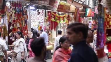 Stock video of people walking in hustle bustle lane at Chandni Chowk Bazar, Old Delhi, India.
