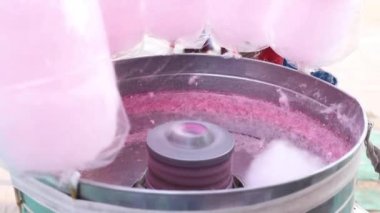 Stock video of making spinning cotton candy in machine.