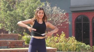 Video of sporty girl in gym outfit doing cardio aerobic full body weight loss exercise.