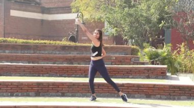 Video of sporty girl in gym outfit doing cardio aerobic full body weight loss exercise.