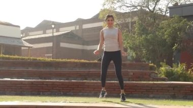 Video of Sporty girl performing full body fat burning aerobic dance.