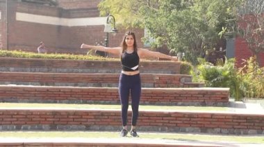 Video of sporty girl in gym outfit doing cardio aerobic full body weight loss exercise.