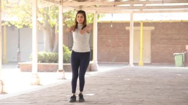 Video of Indian woman performing chest fly exercise.