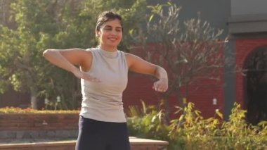 Video footage of woman doing chest cardio workout.