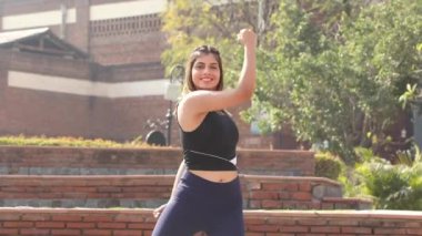 Video of sporty girl in gym outfit doing cardio aerobic full body weight loss exercise.